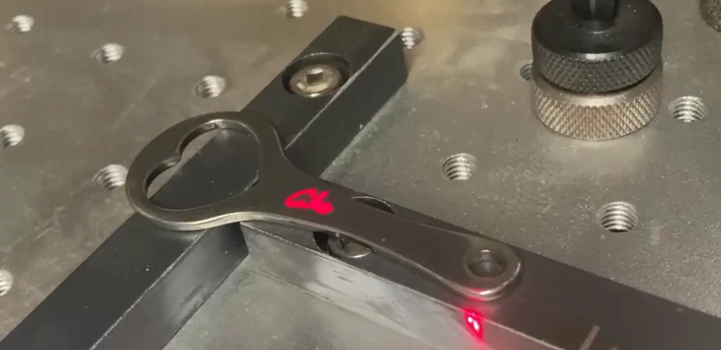 Laser Engraving Services Bottle opener company merchandise being engraved with our laser